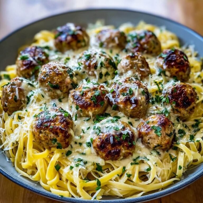 Easy Garlic Butter Meatballs Served Over Creamy Parmesan Linguine Recipe